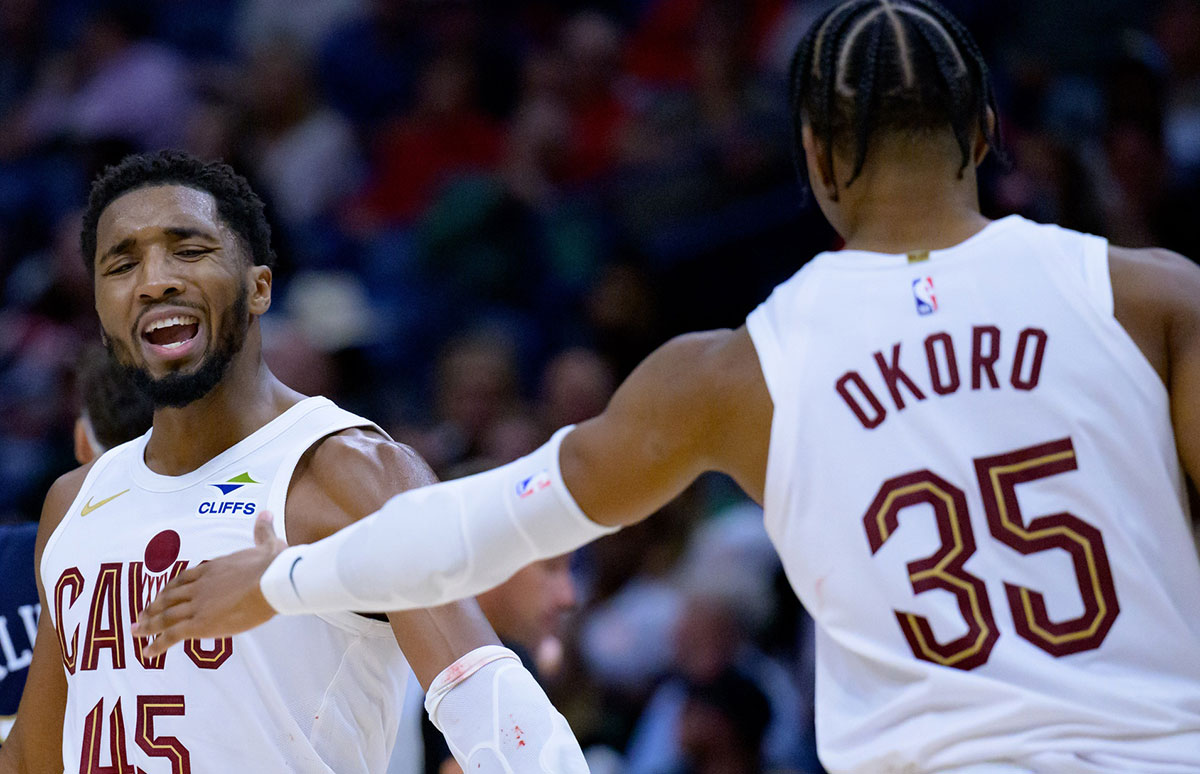 Cleveland Cavaliers guard Donovan Mitchell (45) celebrates with Cleveland Cavaliers forward Isaac Okoro (35) against the New Orleans Pelicans during the fourth quarter at Smoothie King Center.