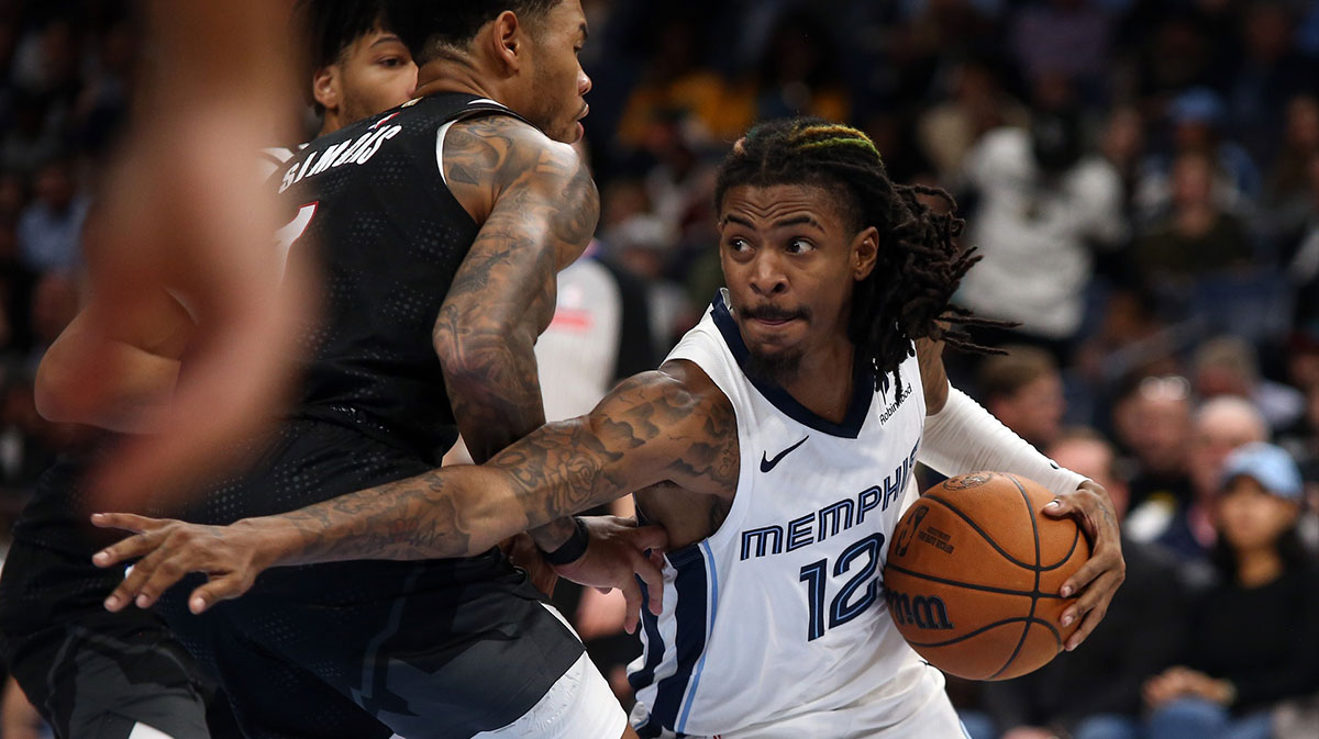 Memphis Grizzlies guard Ja Morant (12) drives to the basket as Portland Trail Blazers guard Anfernee Simons (1) defends during the first half at FedExForum.