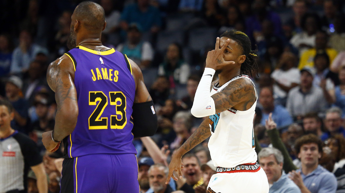 Memphis Grizzlies guard Ja Morant (12) reacts toward Los Angeles Lakers forward LeBron James (23) after a three point basket during the first half at FedExForum.