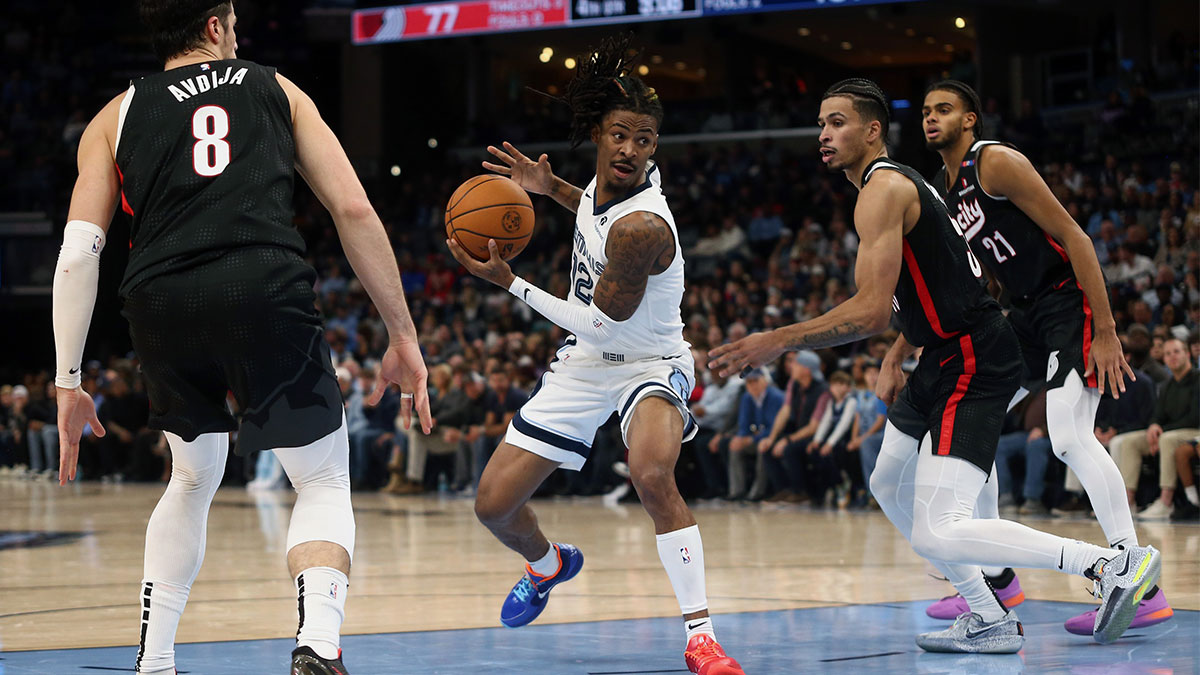 Memphis Grizzlies guard Ja Morant (12) drives to the basket between Portland Trail Blazers forward Deni Avdija (8) and forward Toumani Camara (33) during the second half at FedExForum.