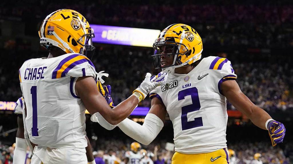 LSU Tigers wide receiver Ja'Marr Chase (1) and wide receiver Justin Jefferson (2) celebrate a touchdown against the Clemson Tigers second quarter in the College Football Playoff national championship game at Mercedes-Benz Superdome.