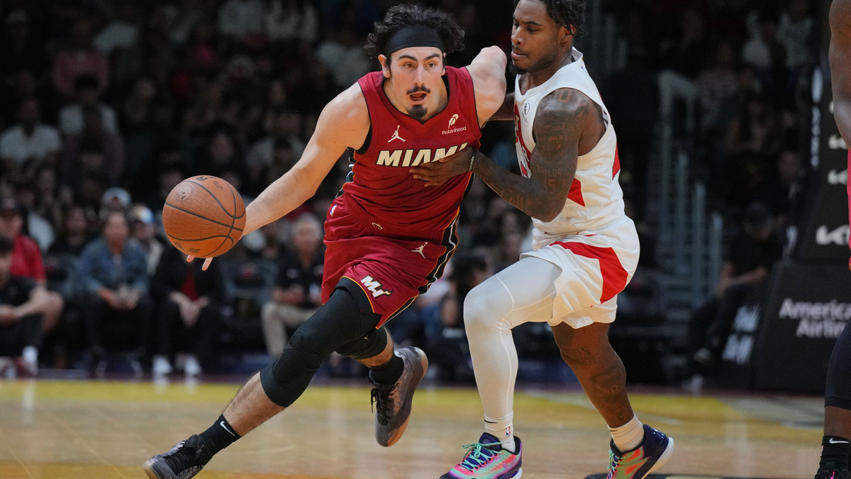 Miami Heat guard Jaime Jaquez Jr. (11) drives around Toronto Raptors guard Davion Mitchell (45) during the second half of an NBA Cup game at Kaseya Center.