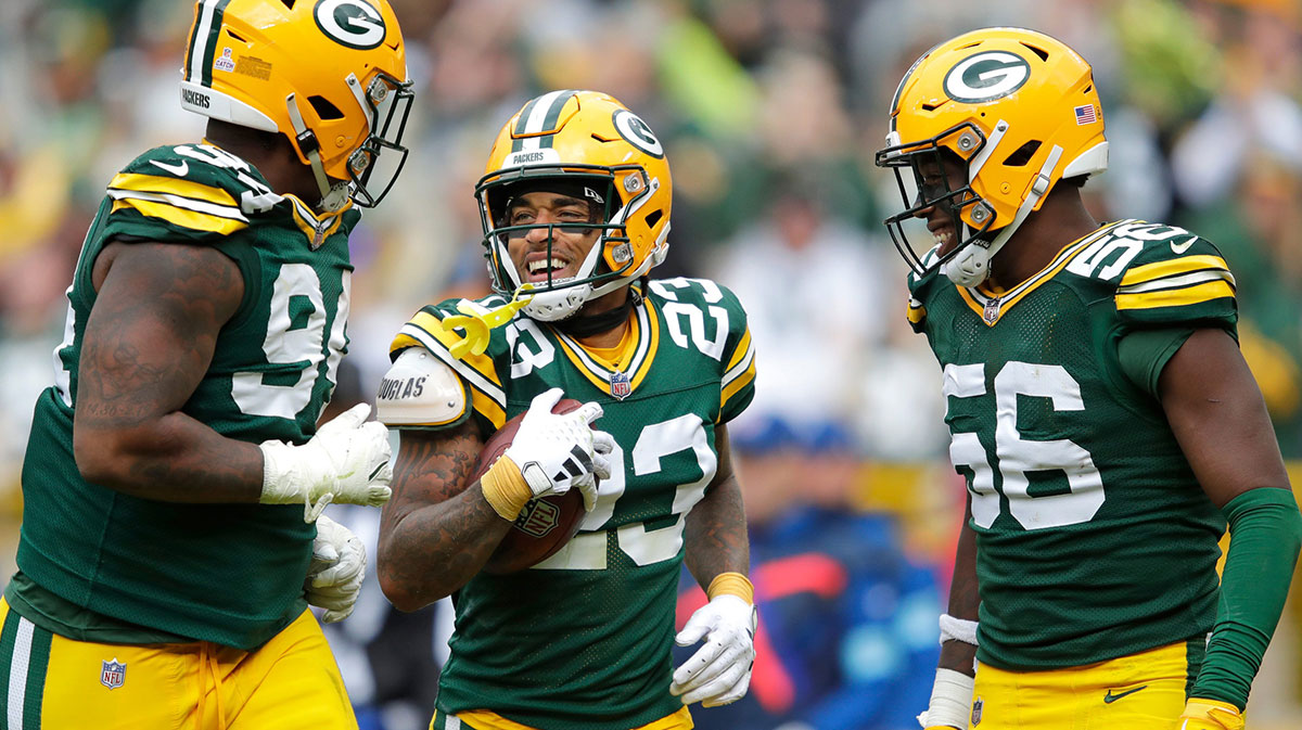 Green Bay Packers cornerback Jaire Alexander (23) celebrates recovering a fumble with teammates defensive end Karl Brooks (94) and linebacker Edgerrin Cooper (56) against the Arizona Cardinals during their football game at Lambeau Field in Green Bay, Wisconsin.