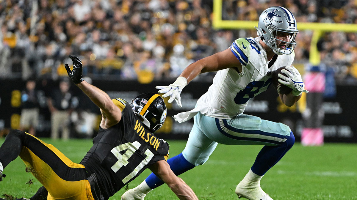 Oct 6, 2024; Pittsburgh, Pennsylvania, USA; Dallas Cowboys tight end Jake Ferguson (87) eludes Pittsburgh Steelers defenders Payton Wilson (41) during the second quarter at Acrisure Stadium.