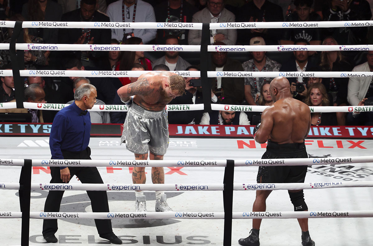 Jake Paul bowing to Mike Tyson during their boxing match.