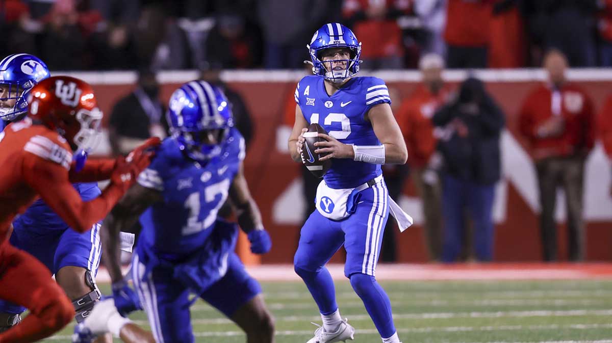 Brigham Young Cougars quarterback Jake Retzlaff (12) drops back to pass against the Utah Utes during the second quarter at Rice-Eccles Stadium.