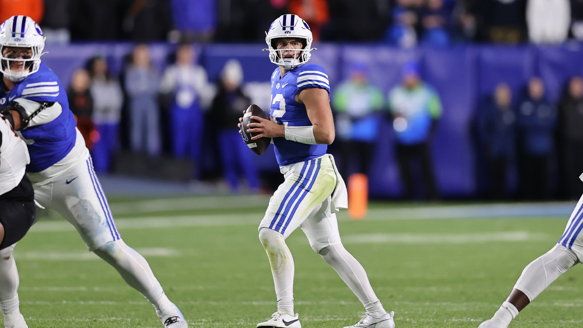 Brigham Young Cougars quarterback Jake Retzlaff (12) drops back to pass against the Oklahoma State Cowboys during the fourth quarter at LaVell Edwards Stadium.