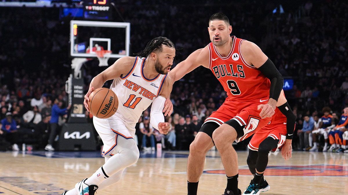 New York Knicks Guard Jalen Brunson (11) Drive to Cart, while defending him Chicago Bulls Center Nikola Vučević (9) during the first half in Madison Square Garden.