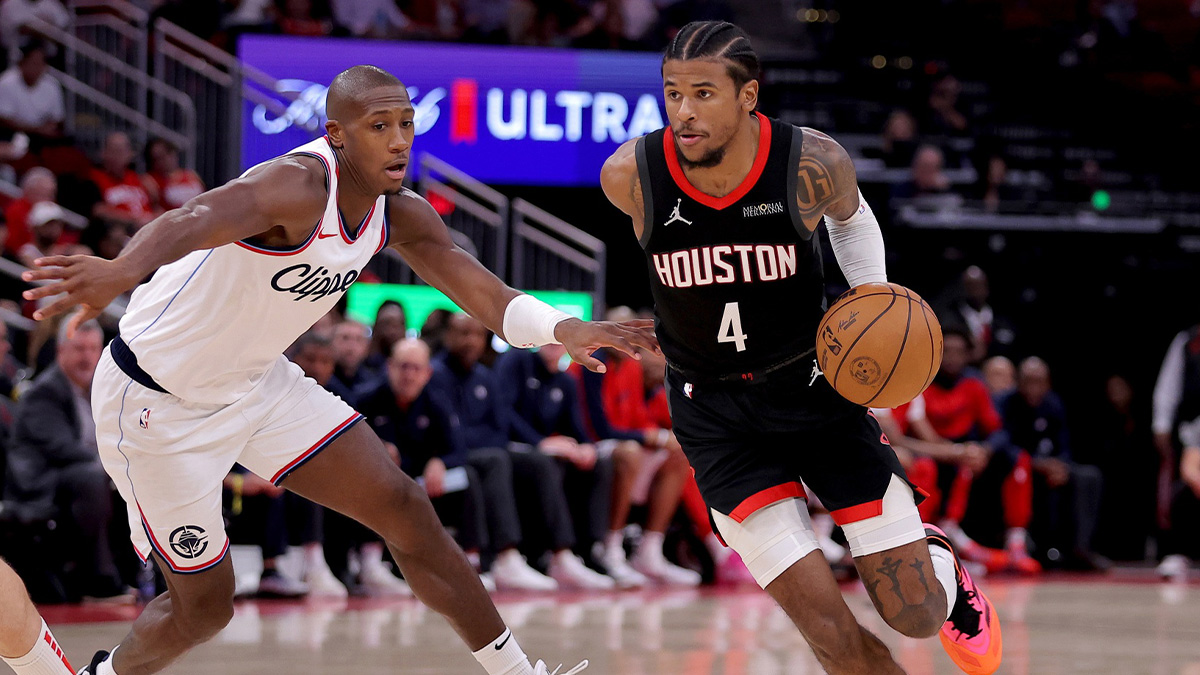 Houston Rockets guard Jalen Green (4) handles the ball against LA Clippers guard Kris Dunn (8) during the third quarter at Toyota Center.