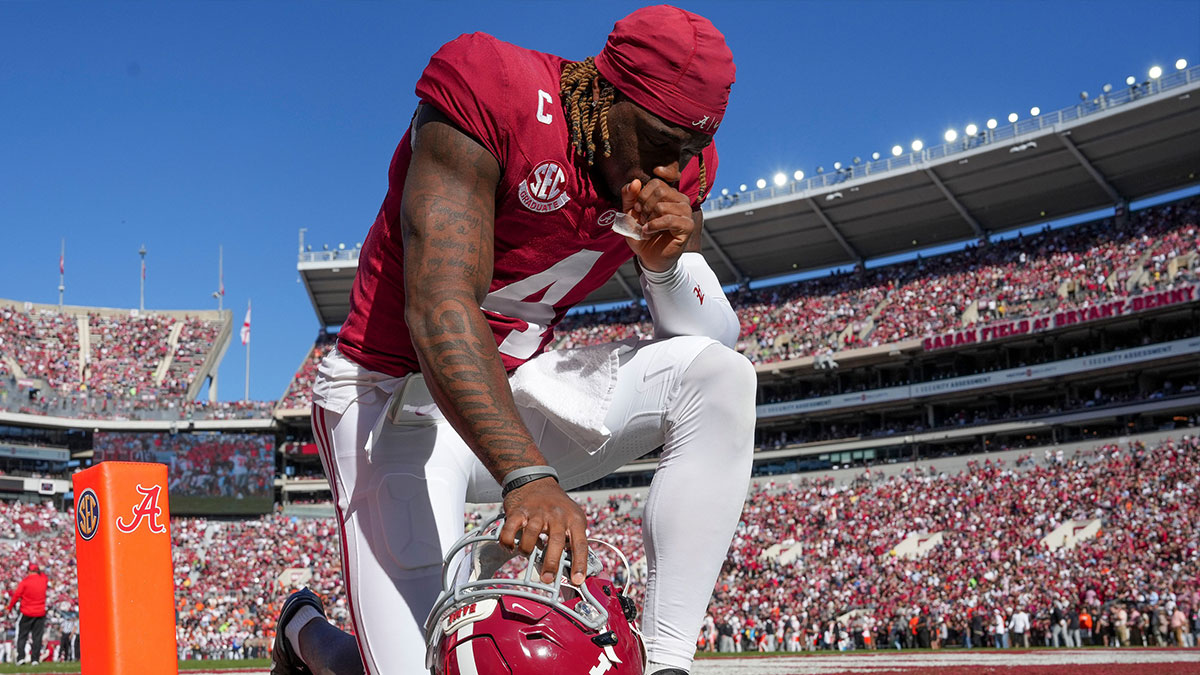 Nov 16, 2024; Tuscaloosa, AL, USA; Alabama Crimson Tide quarterback Jalen Milroe (4) kneels in prayer before the Crimson Tide’s game with Mercer at Bryant-Denny Stadium. 