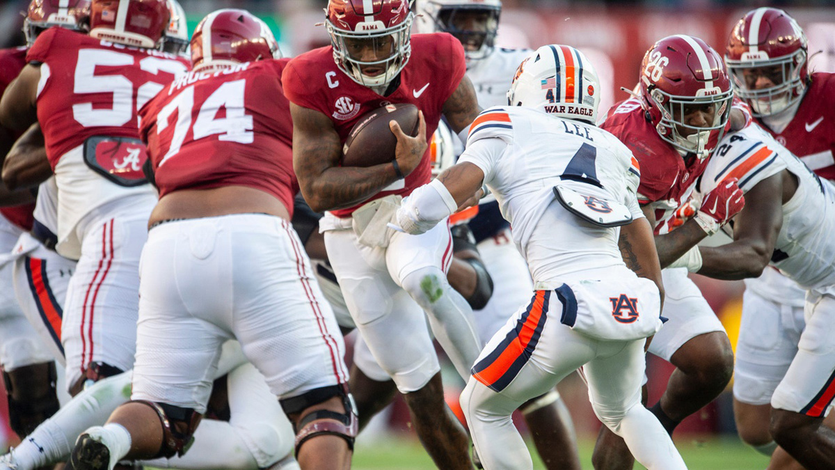Alabama Crimson Tide quarterback Jalen Milroe (4) runs the ball as Auburn Tigers take on Alabama Crimson Tide at Bryant-Denny Stadium in Tuscaloosa, Ala., on Saturday, Nov. 30, 2024. Alabama Crimson Tide leads Auburn Tigers 14-6 at halftime.