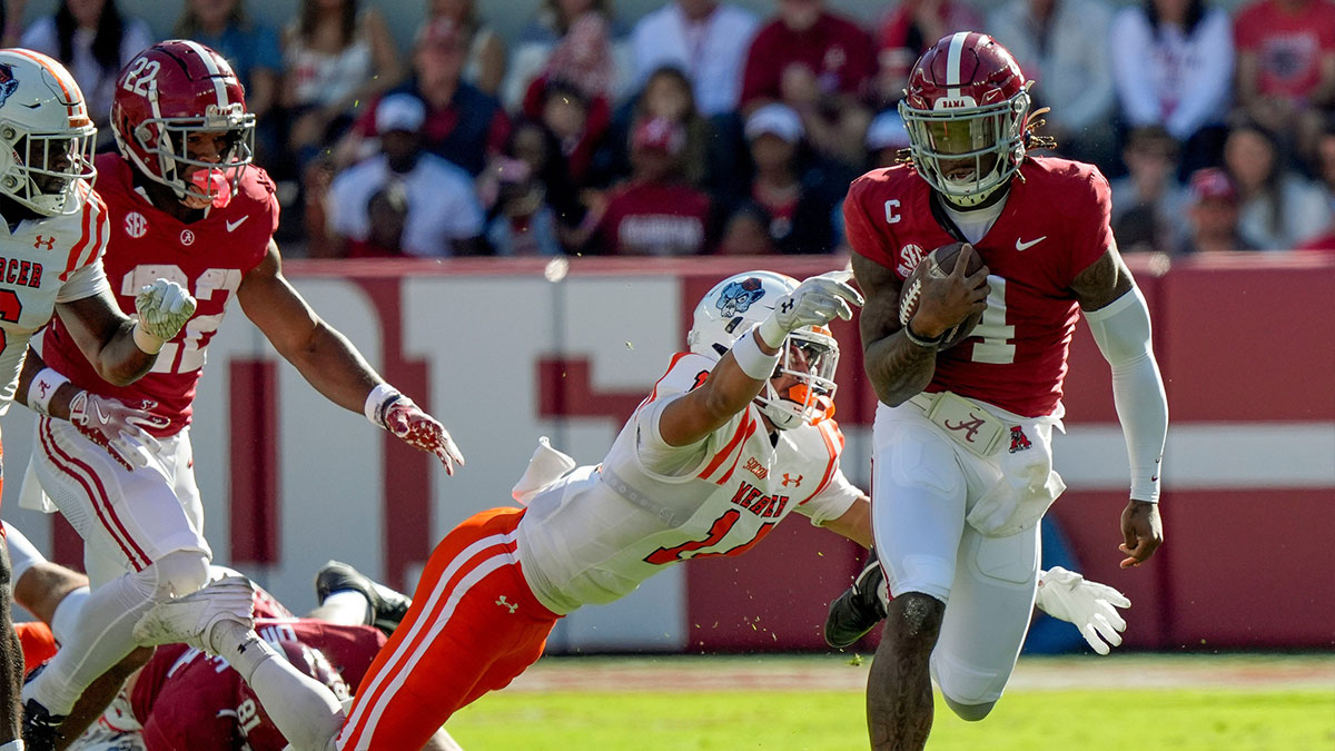 Nov 16, 2024; Tuscaloosa, AL, USA; Mercer safety Chris Joines (14) lunges to try and bring down Alabama Crimson Tide quarterback Jalen Milroe (4) at Bryant-Denny Stadium.