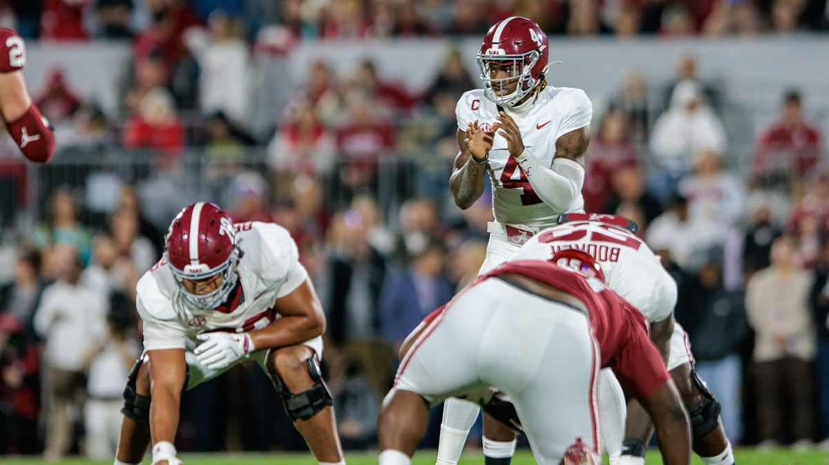 Alabama Crimson Tide quarterback Jalen Milroe (4) behind the line during the first quarter against the Oklahoma Sooners at Gaylord Family-Oklahoma Memorial Stadium