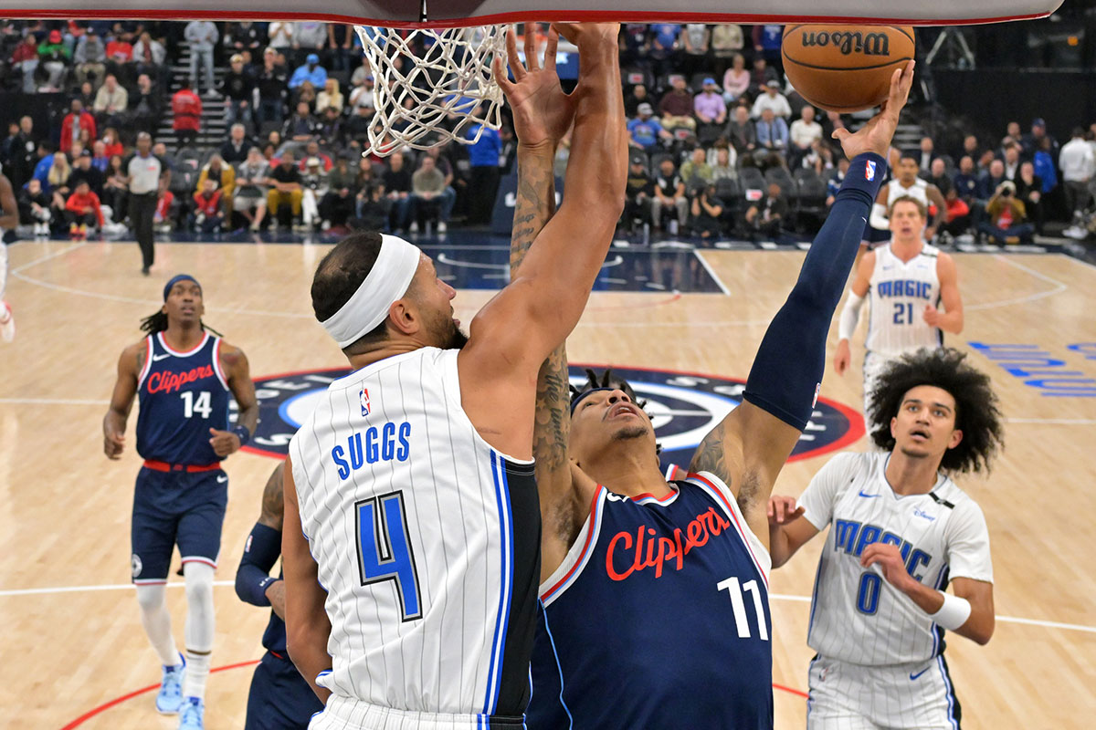 Orlando Magic guard Jalen Suggs (4) defends a shot by Los Angeles Clippers guard Jordan Miller (11) in the first half at Intuit Dome.