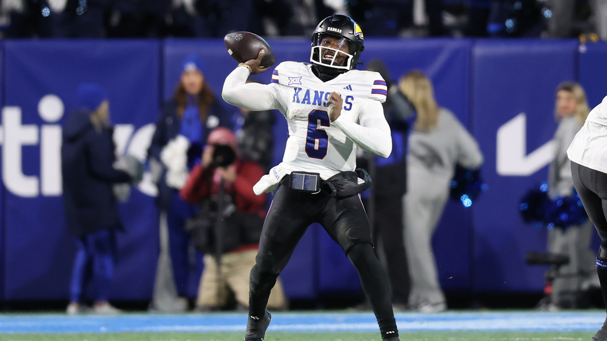 Kansas Jayhawks quarterback Jalon Daniels (6) passes the ball against the Kansas Jayhawks during the fourth quarter at LaVell Edwards Stadium.