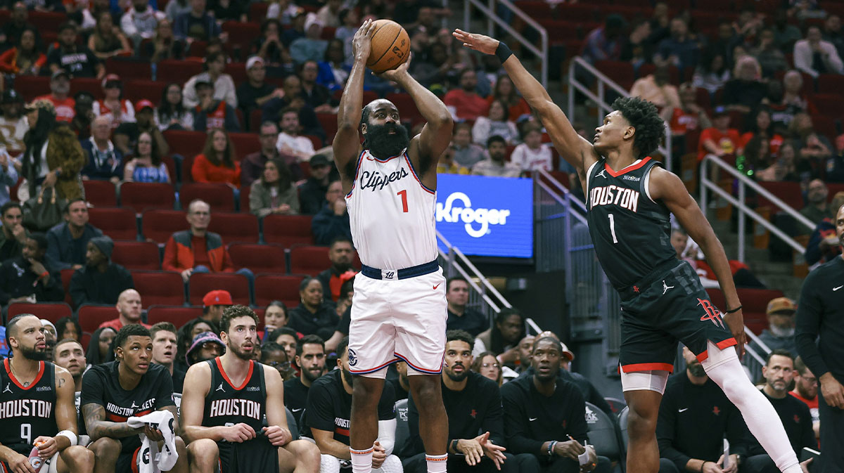 Los Angeles Clippers guard James Harden (1) makes a three-point basket during the second quarter as Houston Rockets forward Amen Thompson (1) defends at Toyota Center.