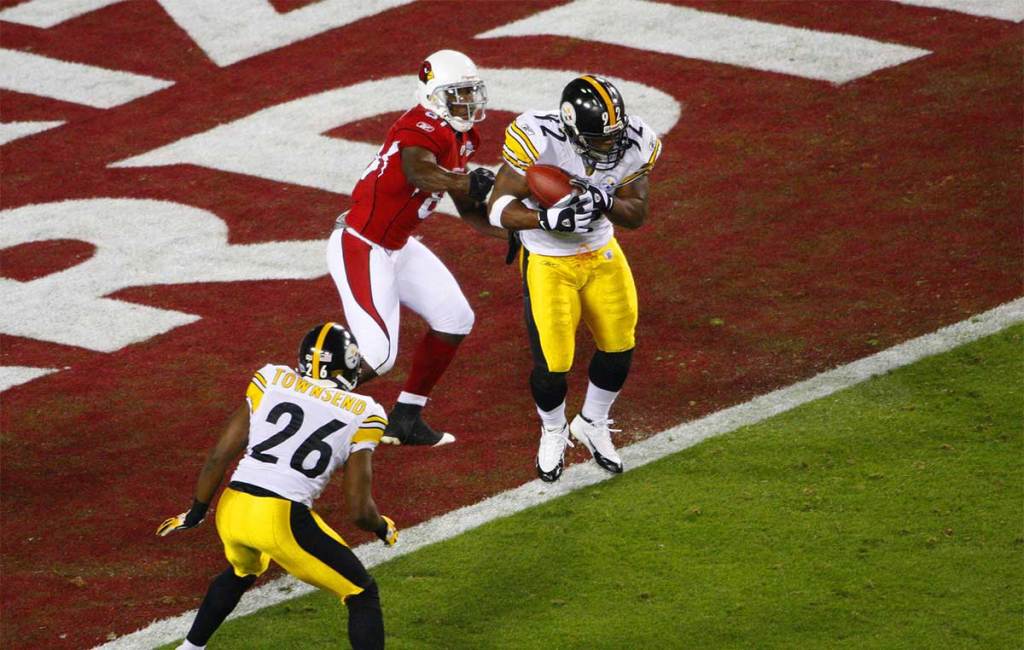 Pittsburgh Steelers linebacker James Harrison (92) intercepts the ball for a touchdown in front of Arizona Cardinals wide receiver Anquan Boldin (81) during the second quarter of Super Bowl XLIII at Raymond James Stadium.