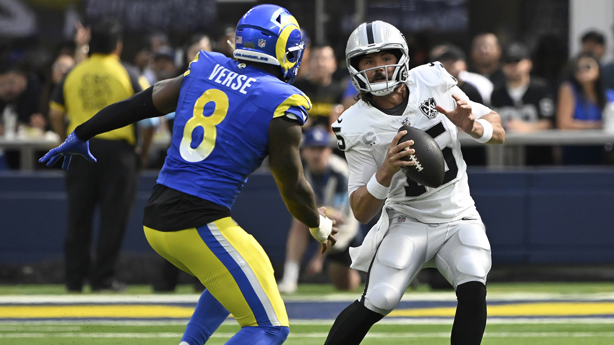 Las Vegas Raiders quarterback Gardner Minshew (15) is chased by Los Angeles Rams linebacker Jared Verse (8) at SoFi Stadium.