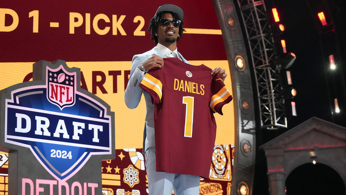 LSU Tigers quarterback Jayden Daniels poses after being selected by the Washington Commanders as the No. 2 pick in the first round of the 2024 NFL Draft at Campus Martius Park and Hart Plaza.