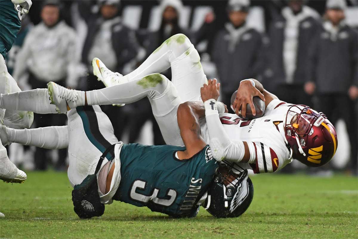 Philadelphia Eagles linebacker Nolan Smith Jr. (3) sacks Washington Commanders quarterback Jayden Daniels (5) during the third quarter at Lincoln Financial Field.