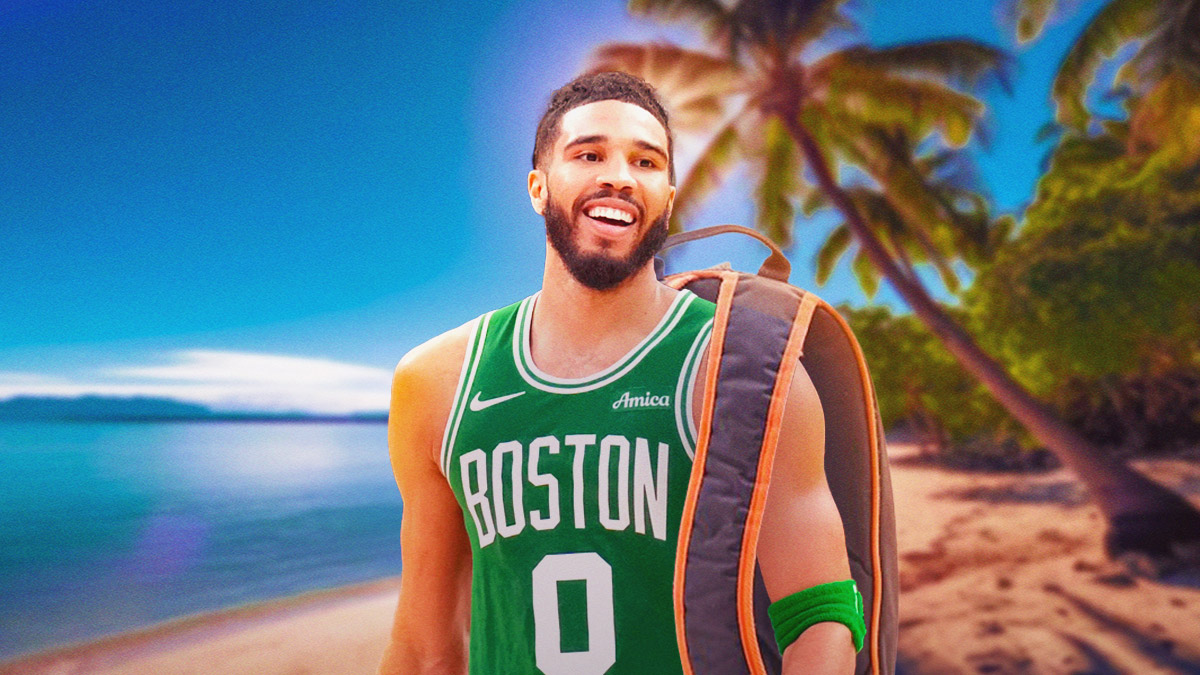 a smiling Jayson Tatum wearing a backpack with a sunny beach in the background