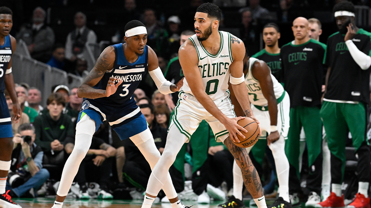 Boston Celtics forward Jayson Tatum (0) looks to pass while covered by Minnesota Timberwolves forward Jaden McDaniels (3) during the second half at TD Garden.