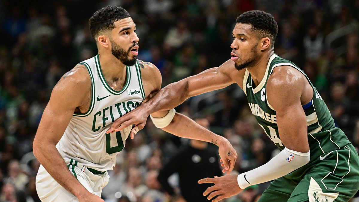 Boston Celtics forward Jayson Tatum (0) and Milwaukee Bucks forward Giannis Antetokounmpo (34) jostle for position in the fourth quarter at Fiserv Forum. 