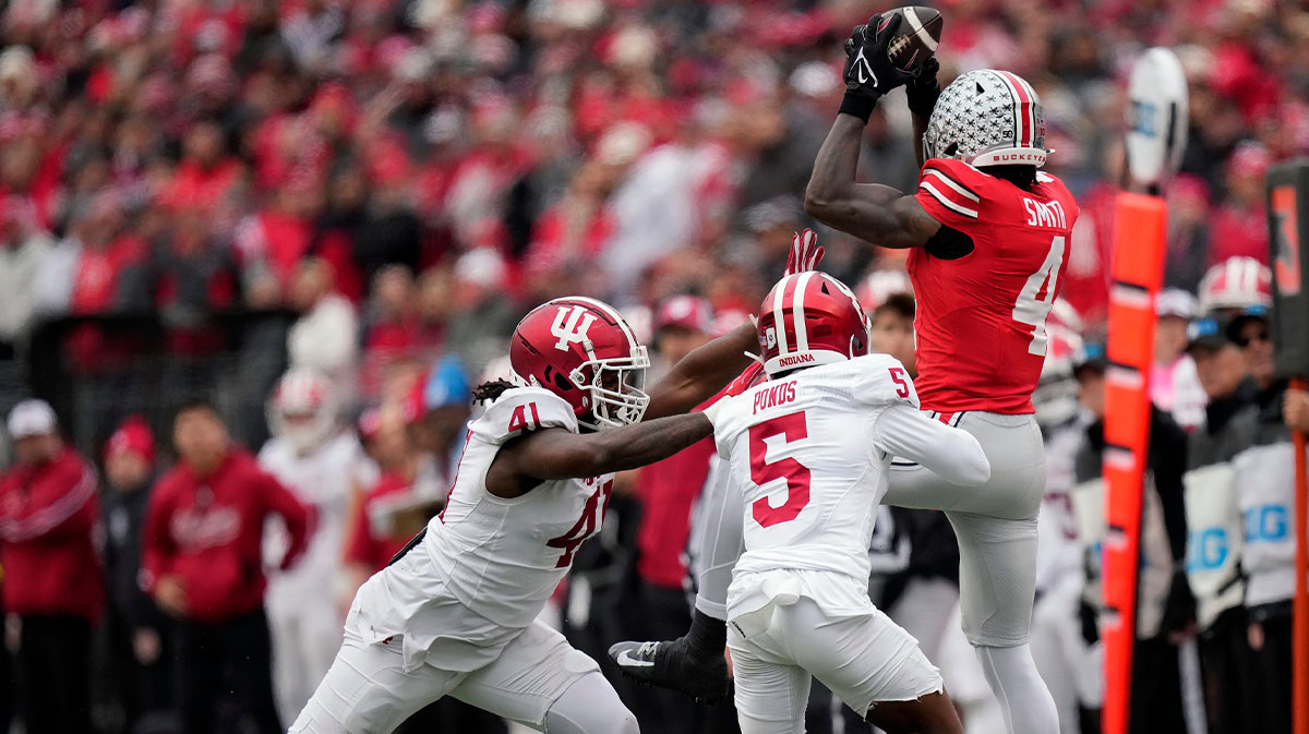 Ohio State Buckeyes wide receiver Jeremiah Smith (4) makes a catch against Indiana Hoosiers defensive lineman Lanell Carr Jr. (41) and defensive back D'Angelo Ponds (5) in the third quarter during the football game