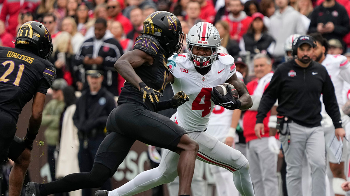 Ohio State Buckeyes wide receiver Jeremiah Smith (4) runs around Northwestern Wildcats defensive back Josh Fussell (13) during the NCAA football game at Wrigley Field