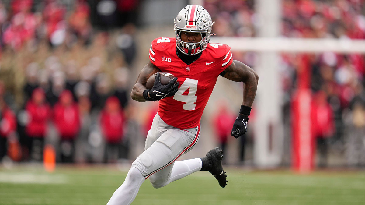 Ohio State Buckeyes wide receiver Jeremiah Smith (4) celebrates with wide receiver Emeka Egbuka (2) and quarterback Will Howard (18) after scoring a touchdown against the Western Michigan Broncos during the first half at Ohio Stadium.