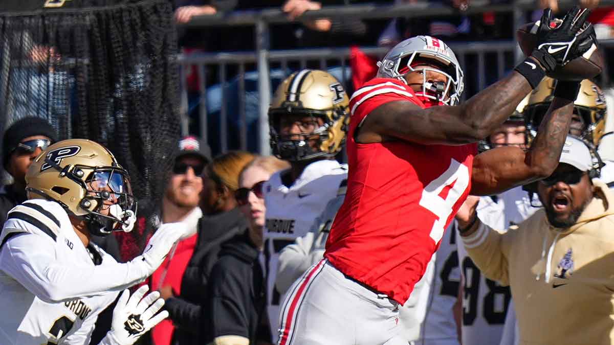 Ohio State Buckeyes wide receiver Jeremiah Smith (4) catches a pass against Purdue Boilermakers defensive back Nyland Green (2) in the first half at Ohio Stadium on Saturday, Nov. 9, 2024 in Columbus, Ohio.
