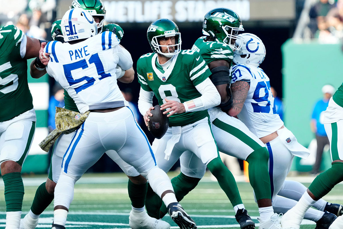 New York Jets quarterback Aaron Rodgers (8) looks for an open receiver as New York Jets offensive tackle Olu Fashanu (74) and other teammates try to protect him, Sunday, November 17, 2024, in East Rutherford.