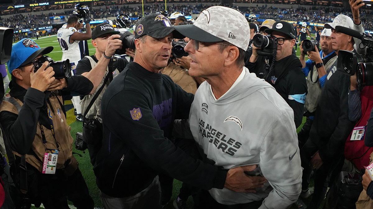 Baltimore Ravens coach John Harbaugh (left) shakes hands with brother and Los Angeles Chargers coach Jim Harbaugh after the game at SoFi Stadium.