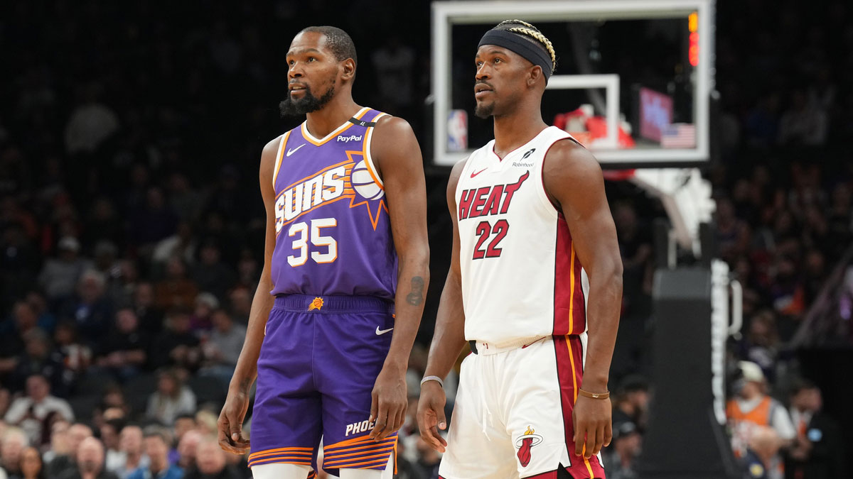 Phoenix Suns forward Kevin Durant (35) and Miami Heat forward Jimmy Butler (22) watch the first half at Footprint Center.