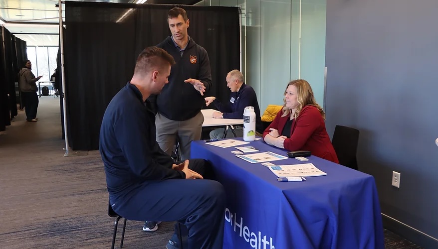 Joe Rogowski (standing up) helps former professional basketball players stay informed and aware of their health problems through the National Basketball Retired Players Association’s health screening program.