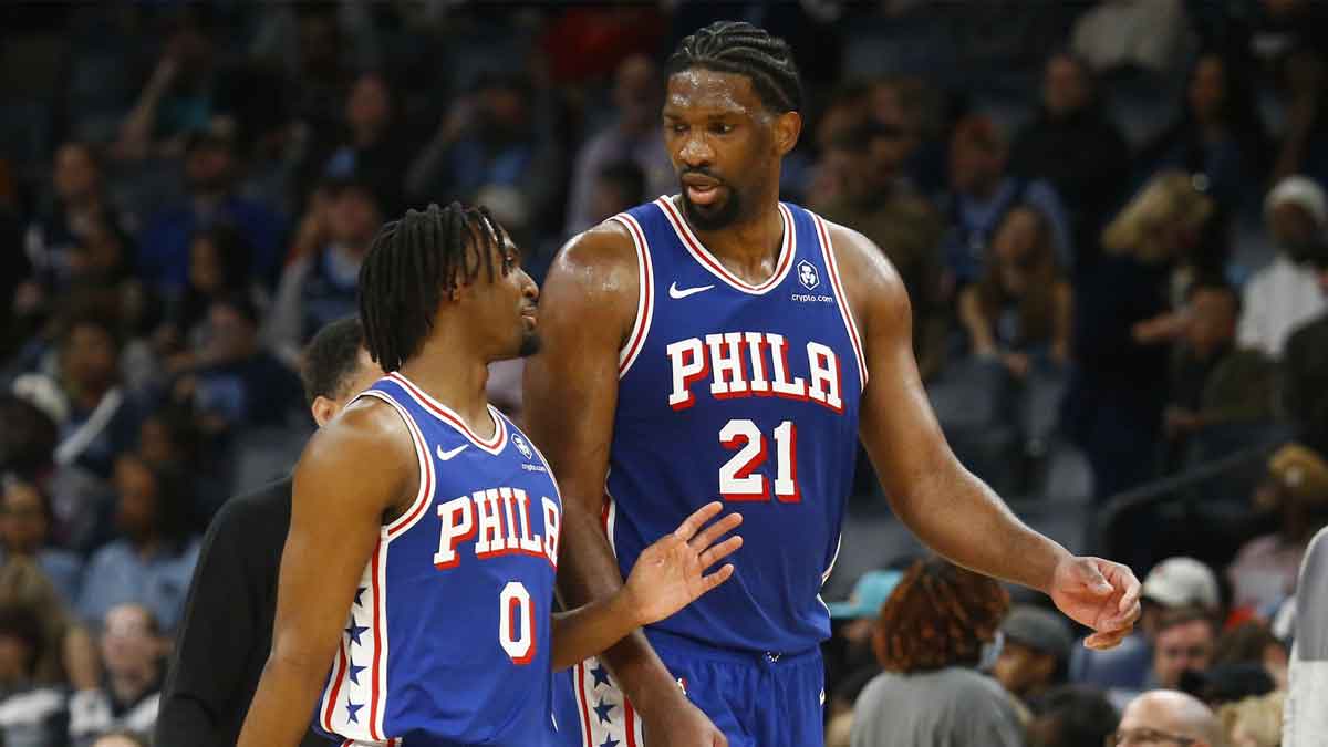 Philadelphia 76ers guard Tyrese Maxey (0) and center Joel Embiid (21) talk as they walk off the court at half time against the Memphis Grizzlies at FedExForum