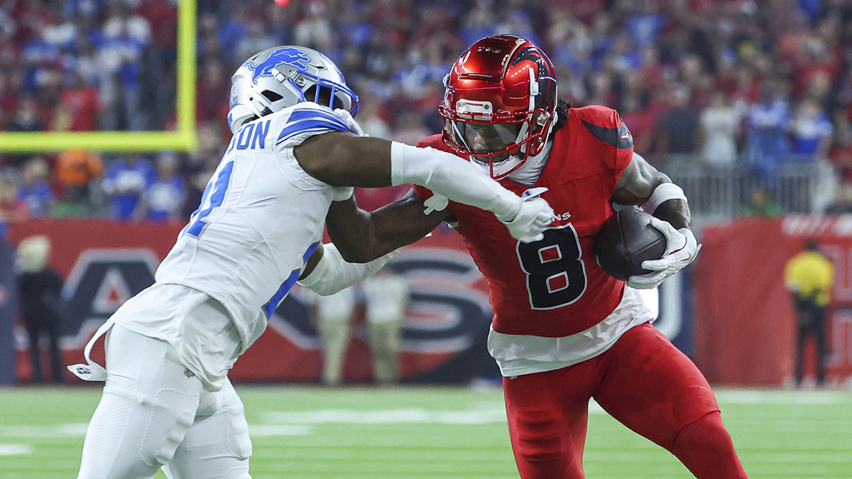 Houston Texans wide receiver John Metchie III (8) makes a reception as Detroit Lions cornerback Amik Robertson (21) defends during the first quarter at NRG Stadium.