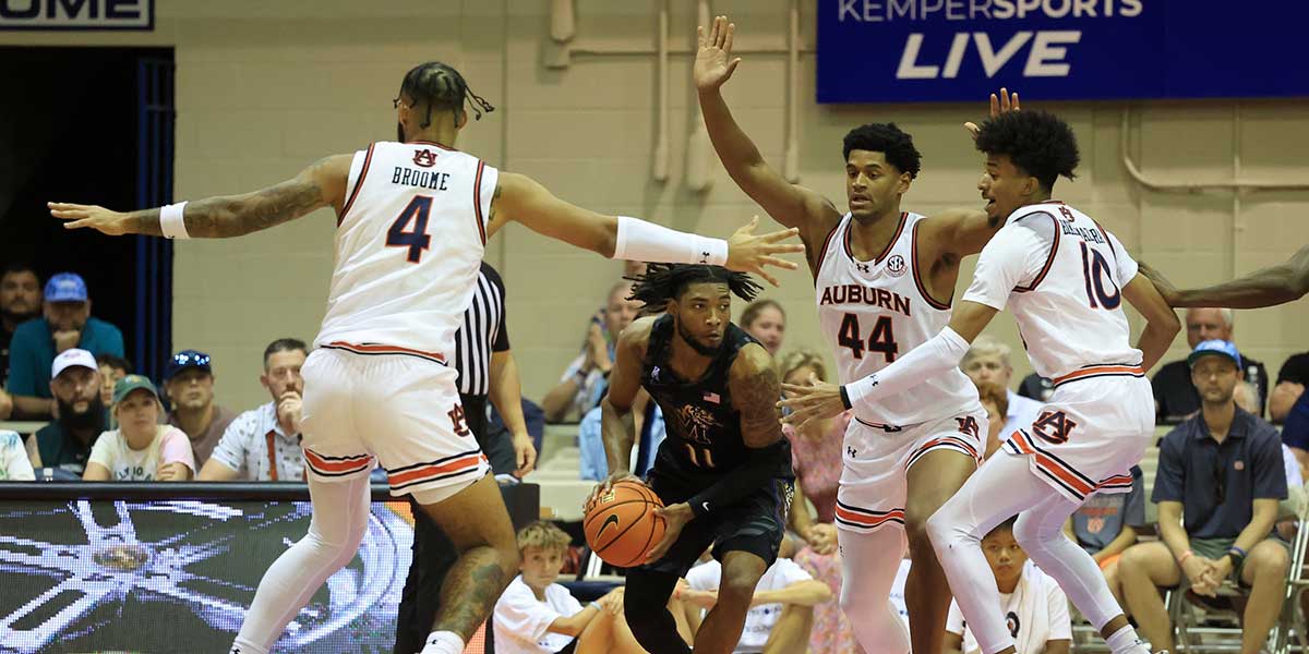 Memphis Tigers guard Tyrese Hunter (11) is defended by Auburn Tigers forward Johni Broome (4), center Dylan Cardwell (44), and guard Chad Baker-Mazara (10) in the first half at Lahaina Civic Center.