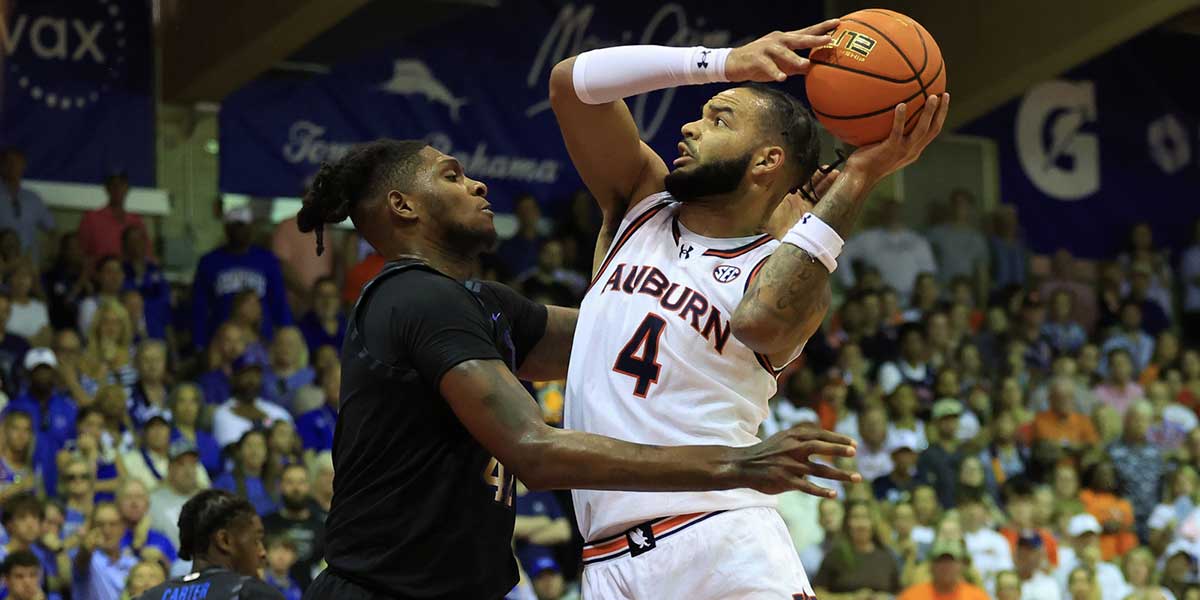 Auburn Tigers forward Johni Broome (4) shoots over Memphis Tigers forward Dain Dainja (42) in the first half at Lahaina Civic Center.
