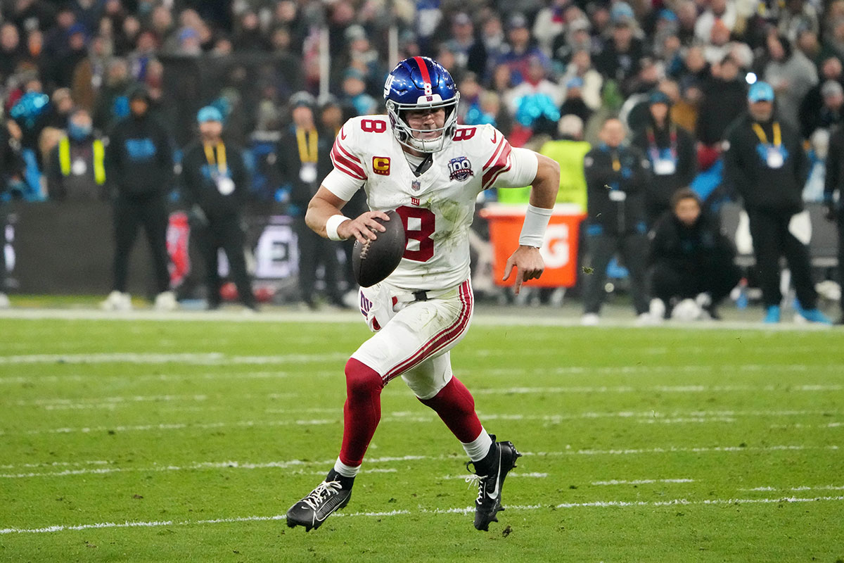 New York Giants quarterback Daniel Jones (8) carries the ball against the New York Giants in the second half during the 2024 NFL Munich Game at Allianz Arena