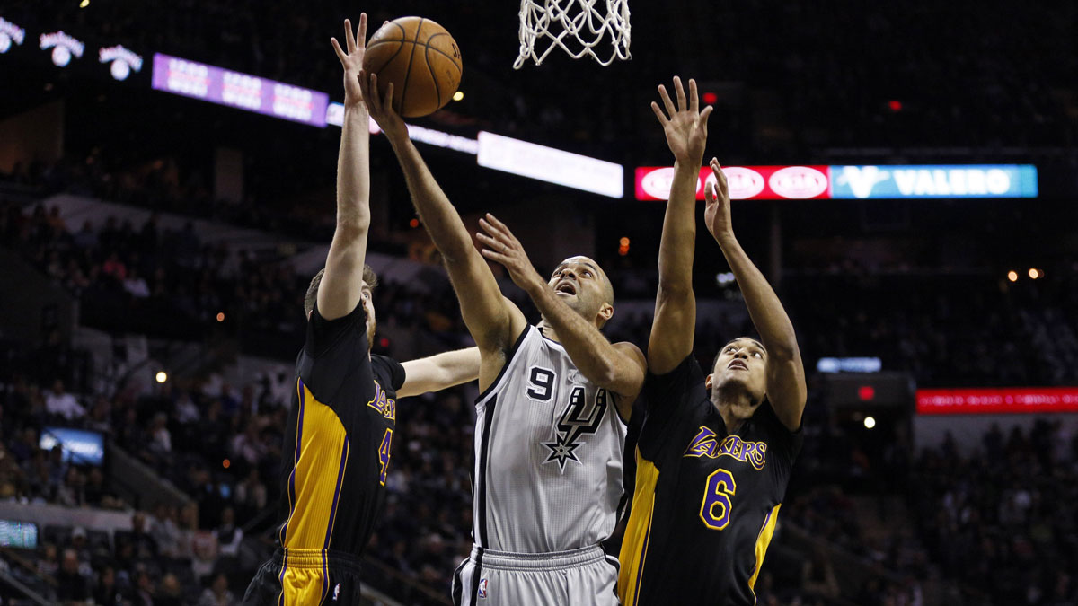 San Antonio Spurs point guard Tony Parker (9) shoots the ball as Los Angeles Lakers power forward Ryan Kelly (4,L) and point guard Jordan Clarkson (6,R) defend during the first half at AT&T Center.