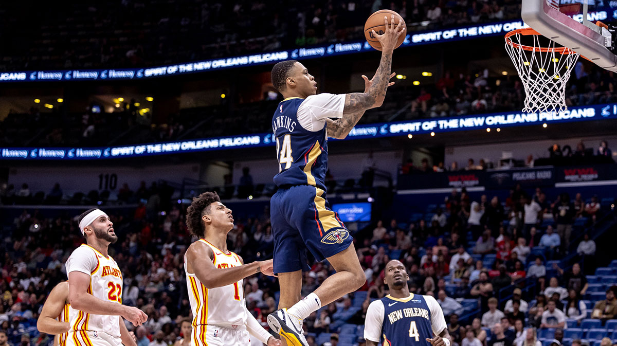 New Orleans Pelicans guard Jordan Hawkins (24) drives to the basket against Atlanta Hawks forward Jalen Johnson (1) during the second half at Smoothie King Center.