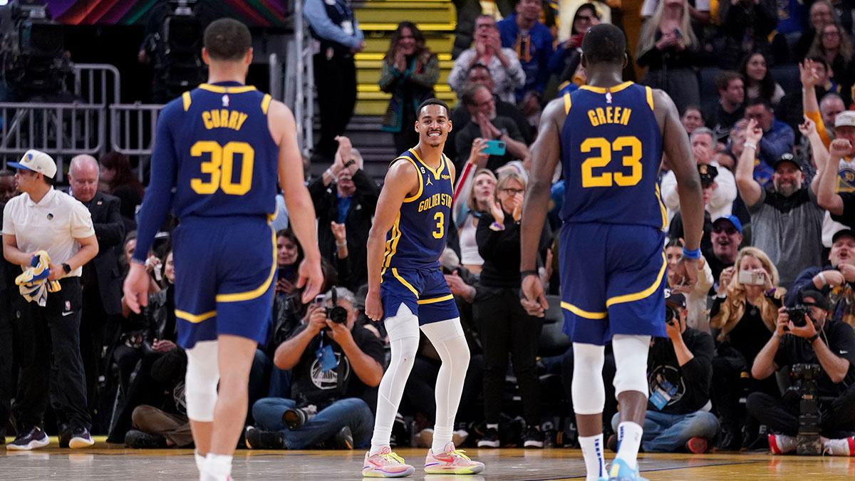 Golden State Warriors guard Jordan Poole (3) reacts in front of guard Stephen Curry (30) and forward Draymond Green (23) after making a three point basket against the Oklahoma City Thunder in the fourth quarter at the Chase Center.