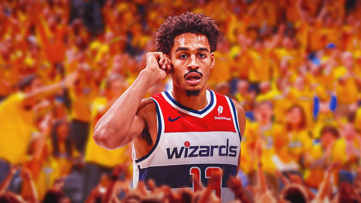 Jordan Poole in Wizards uniform surrounded by Warriors fans