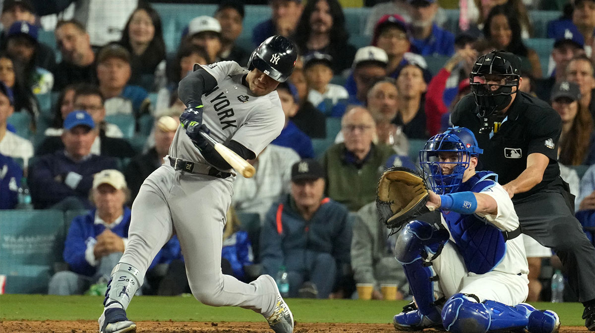 New York Yankees outfielder Juan Soto (22) hits a single against the Los Angeles Dodgers in the ninth inning for game two of the 2024 MLB World Series at Dodger Stadium.