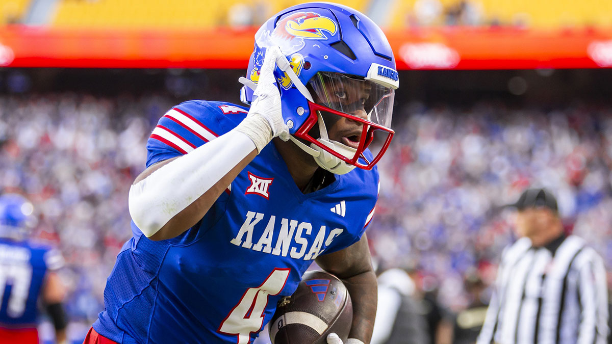 Kansas running back Devin Neal (4) reacts to fans after scoring a rushing touchdown during the 2nd quarter between the Kansas Jayhawks and the Colorado Buffaloes at GEHA Field at Arrowhead Stadium