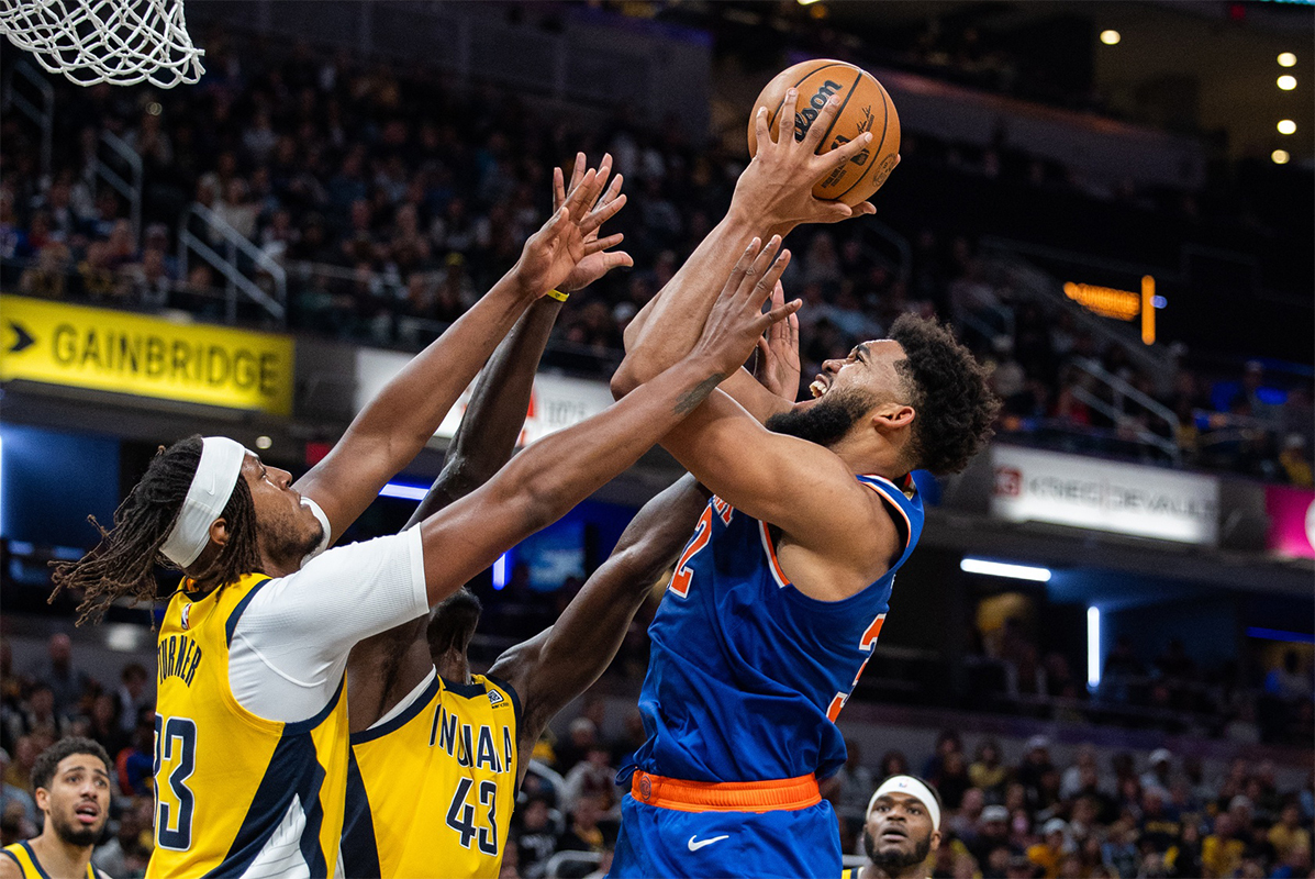 New York Knicks center Karl-Anthony Towns (32) shoots the ball while Indiana Pacers center Myles Turner (33) defends in the second half at Gainbridge Fieldhouse.