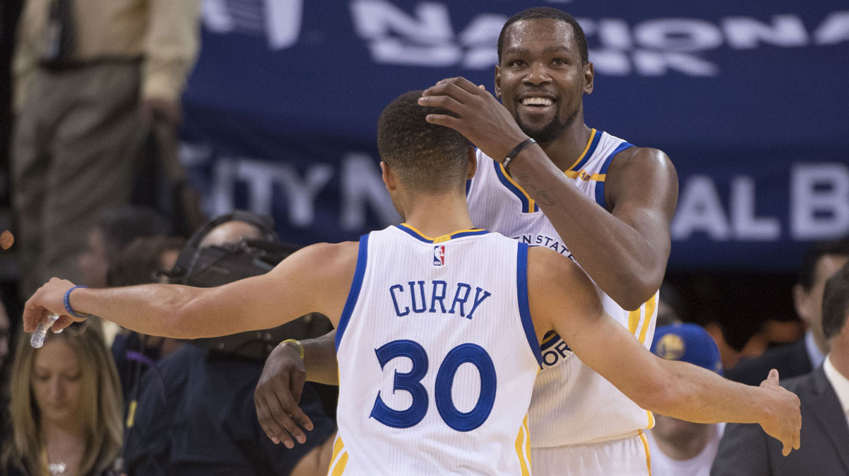 Golden State Warriors forward Kevin Durant (35, right) hugs guard Stephen Curry (30) after the game against the Toronto Raptors at Oracle Arena. The Warriors defeated the Raptors 121-111.