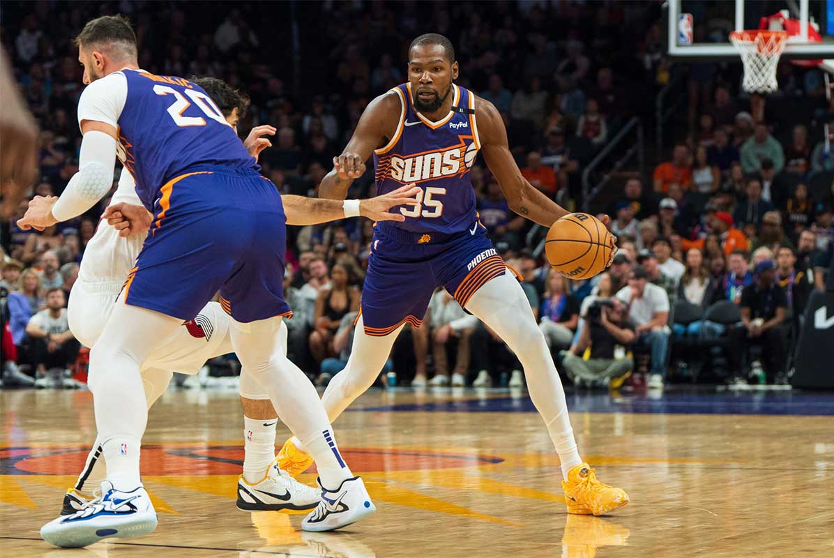 Phoenix Suns forward Kevin Durant (35) dribbles through the screen set by center Jusuf Nurkić (20) in the first half during a game against the Portland Trail Blazers at Footprint Center.