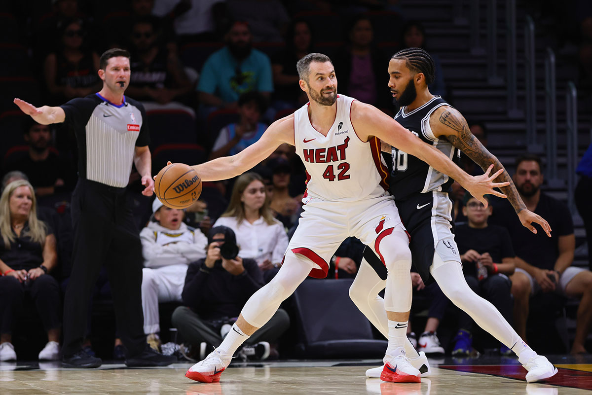 Miami heat forward, Kevin Love (42) protects the ball from San Antonio, forward Julian Champagnie (30) during the second quarter in the Cashier Center. 